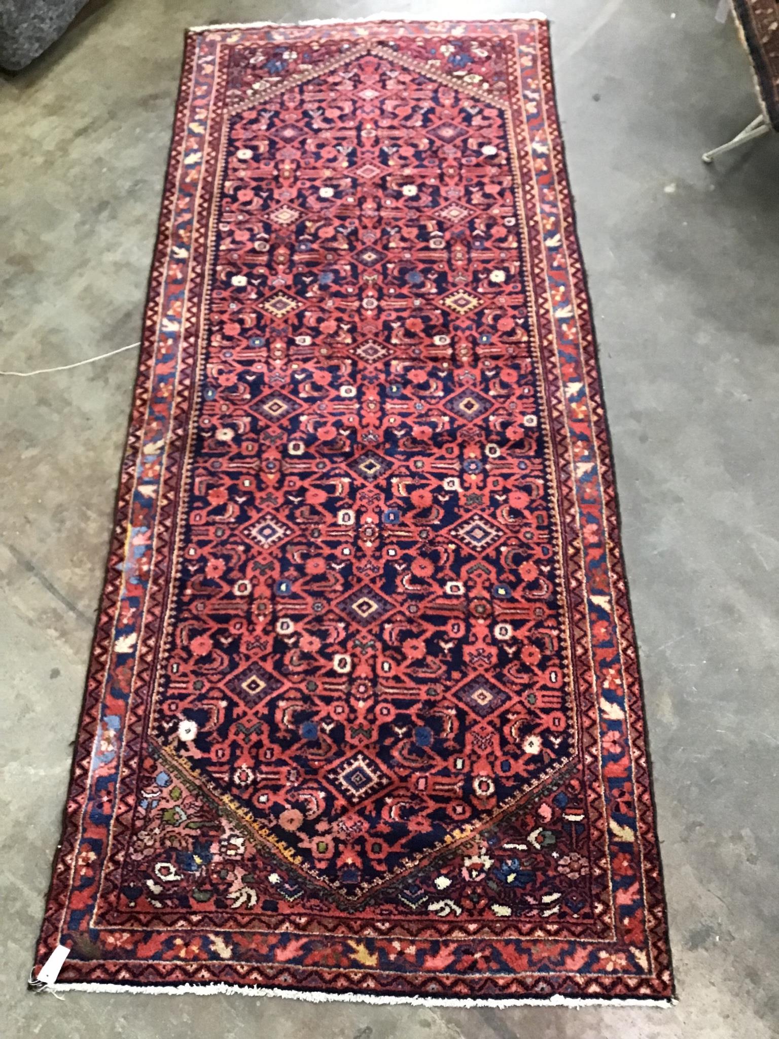 A North West Persian blue ground hall carpet, 304 x 127cm